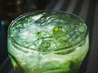 mojito cocktail with lime slices, mint leaves and ice closeup