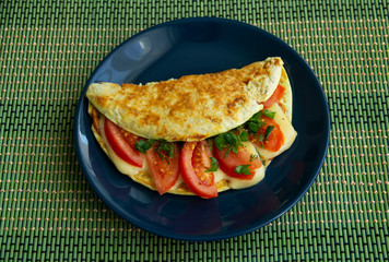 Oatmeal with tomatoes, cheese and herbs on a plate