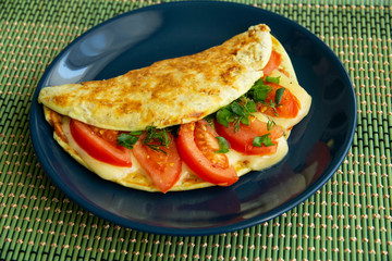 Oatmeal with tomatoes, cheese and herbs on a plate