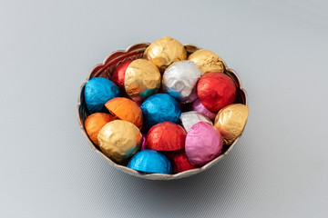 Colorful Chocolate candies on the gray background.