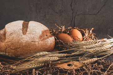 a loaf of bread and fresh chicken eggs