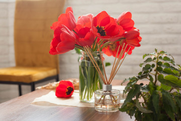 bouquet of red tulips in the home interior. beauty items