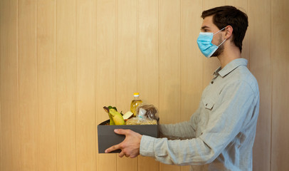 A man in a facial mask delivered a box with donations. Donations to the needy and the starving...