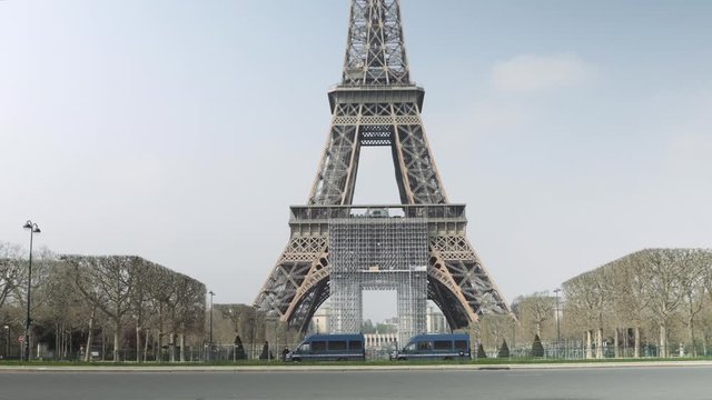Paris, France / 04 13 2020 : Police trucks guarding Eiffel tower in Paris during coronavirus lockdown. Champs de Mars 4K