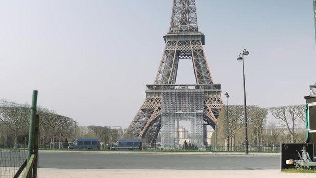 Paris, France / 04 13 2020: Police trucks guarding Eiffel tower in Paris during coronavirus lockdown. Champs de Mars 4K