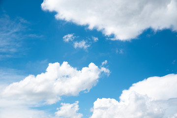 Naklejka na ściany i meble Beautiful blue sky and close-up white clouds. Nature background.