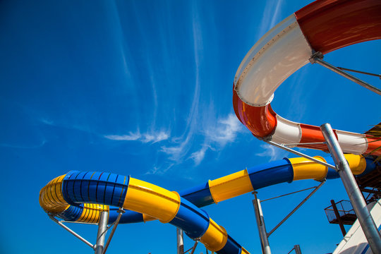 Colorful Waterpark Tubes And Pool In Tropical Aquapark