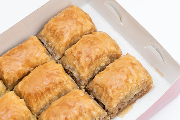 Turkish Ramadan Dessert Baklava isolated on beige plate.