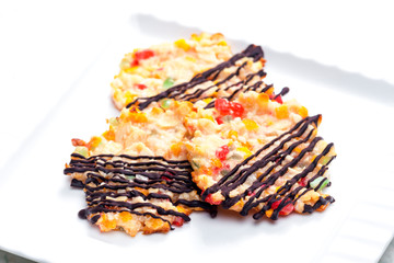 still life of cookies with candy fruit, nuts and chocolate