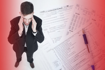Stress due to taxes. Concept - a man cannot fill out a tax return. Concept - services for filling out form 1040. Guy holds his head. U.S. Individual Income Tax Return. Guy has depression.