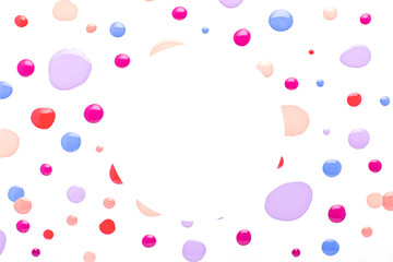 Colorful nail polish drops on white, fashion and beauty concept. Nail polish palette in trendy colors, top view. Frame with polish drops on white table top
