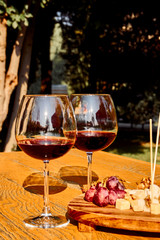 Glasses Of Fine Red Wine With Grape and Cheese
