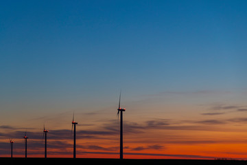 Fototapeta na wymiar Wind turbines during sunrise, Southern Moravia, Czech Republic
