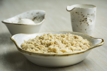 Crumble with custard on light Background