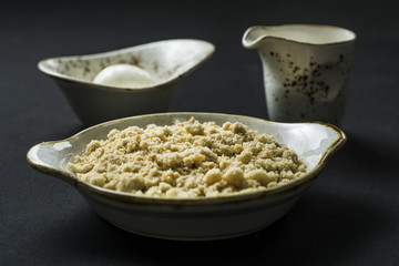 Crumble with custard on dark Background