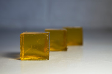 Yellow apple jelly cubes. Perspective.