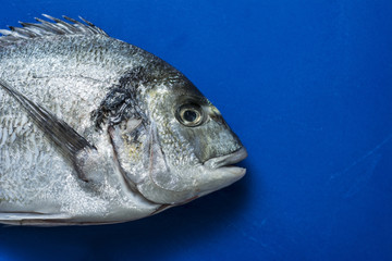 Fish on blue chopping board