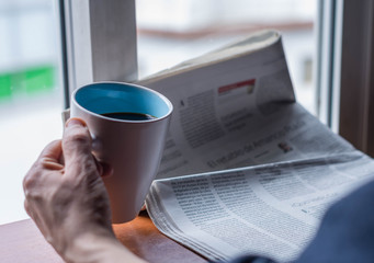 person reading the news in the newspaper