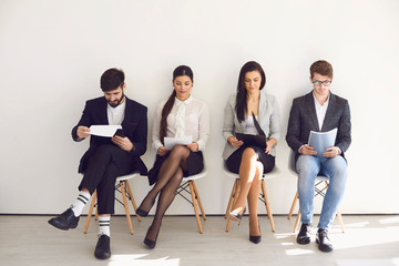 Fototapeta premium Business people waiting for job interview recruitment sitting on a chair in the office.