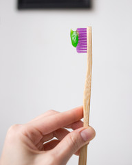 pink bamboo toothbrush with the green toothpaste