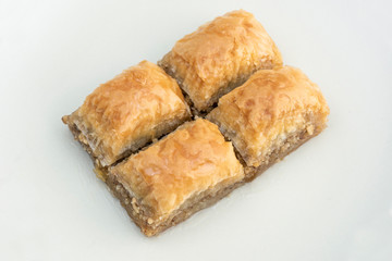 Turkish Ramadan Dessert Baklava isolated on beige plate.