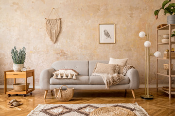 Stylish scandi compostion at living room interior with design gray sofa, wooden coffee table,...