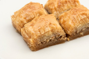Turkish Ramadan Dessert Baklava isolated on beige plate.