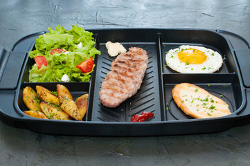 Breakfast, cutlet or steak, tomato salad, fried potato, crouton and fried egg