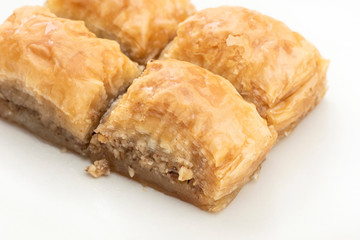 Turkish Ramadan Dessert Baklava isolated on beige plate.