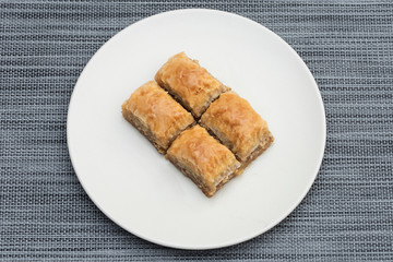 Turkish Ramadan Dessert Baklava isolated on beige plate.
