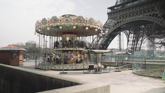 Paris, France / 04 13 2020 : Closed carousel and deserted Eiffel tower during coronavirus / Covid-19 lockdown in Paris 4K