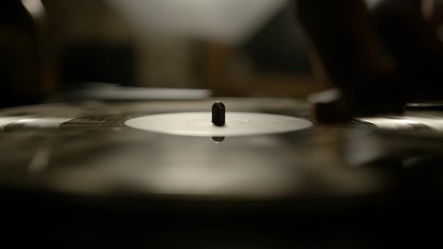 Putting vinyl record on turntable and putting stylus needle on