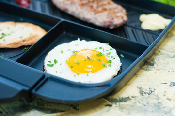 Breakfast, fried steak or cutlet, salad with tomato and green vegetables, toast, potato, egg closeup, light background. Concept healthy eating, diet, menu, nutritious food.