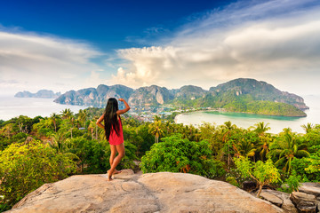 Beautiful woman enjoying wonderful sunrise on Phi Phi Don island view point on background amazing...