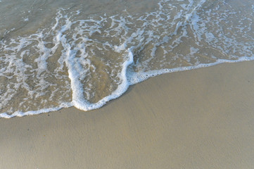 Top View on waves on beach aerial view, crystal clear water with beautiful foam