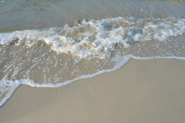 Top View on waves on beach aerial view, crystal clear water with beautiful foam