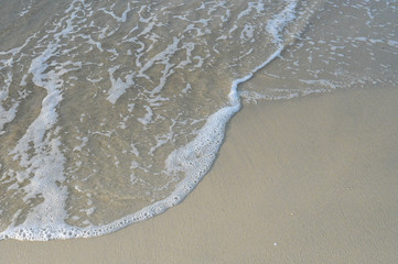 Top View on waves on beach aerial view, crystal clear water with beautiful foam