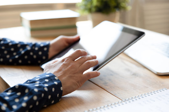 Close up young mixed race girl holding digital tablet. Female student web surfing internet, spending time in social networks. Millennial indian businesswoman working online, using applications.