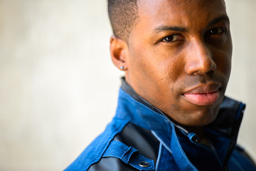 Fototapeta premium Face of young handsome African man looking over shoulder