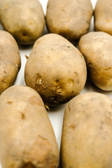 Potatoes or Solanum tuberosum, shots on isolated white background.