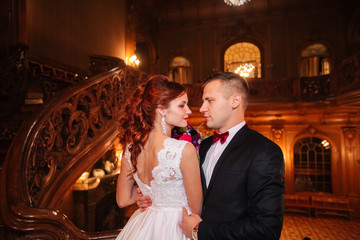 Elegant wedding couple at old vintage house and palace with big wooden stairs