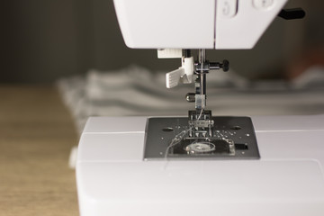 Selective focus on sewing machine was used by a woman,Used sewing machines.