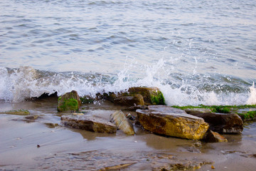 Sea waves crash and splash on rocks