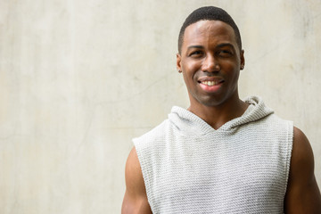 Face of happy young African man smiling ready for gym