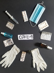 one medical protective mask, antiseptic, pills, vitamins, vaccine isolated on black background. Disposable surgical face mask covers the mouth and nose. Coronavirus quarantine, covid-19 protection