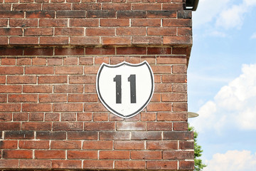 Brick wall with the number eleven on it.  