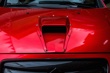 Hood with air intake close-up. Exclusive tuned car at the automobile exhibition.