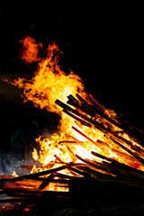 Bonfire that burns on a dark background, wood burning flame.