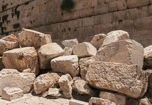 stones thrown by the romans from the second temple to the street below after the destruction of the temple in 70 CE with the Western Wall in the background