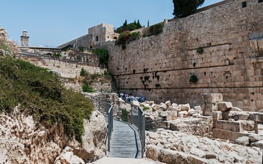 the southern section of the kotel western wall of the second temple showing people praying in the...